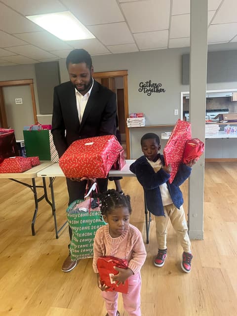 Families receiving gifts at the Romans 116 Church Christmas Giveaway (1)